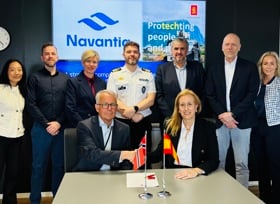 Representatives from KONGSBERG and Navantia signing an agreement and shaking hands